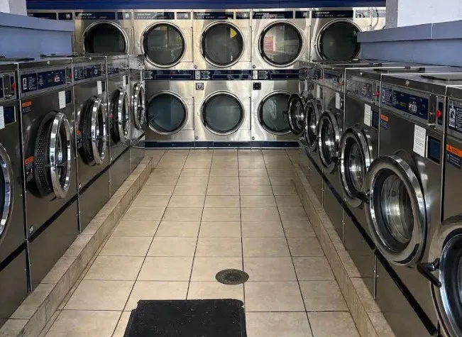 Rows of washers and dryers inside Spin N Dry